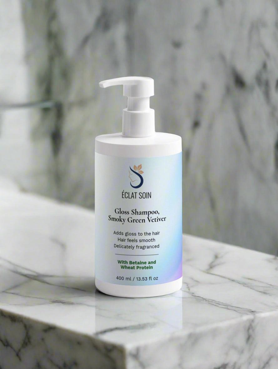 Eclat Soin Gloss Shampoo with Aloe Vera & Wheat Protein in a sleek pump bottle on a marble countertop